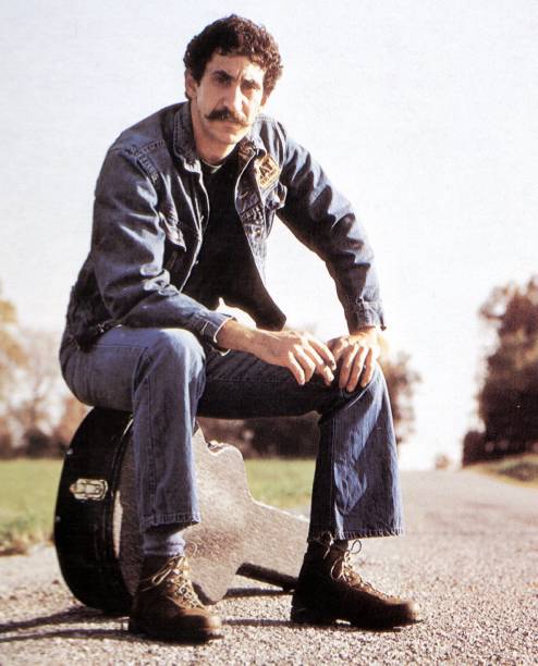 Photo of Jim CROCE; Posed full length portrait of Jim Croce, sitting on guitar case